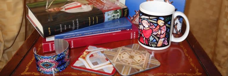 Items for sale in the Trinity shop:  mugs, books, coasters, and more.