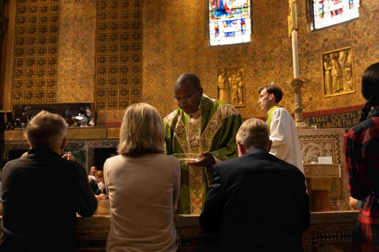 Trinity 0924 399 Priest Gives Communion To Three People
